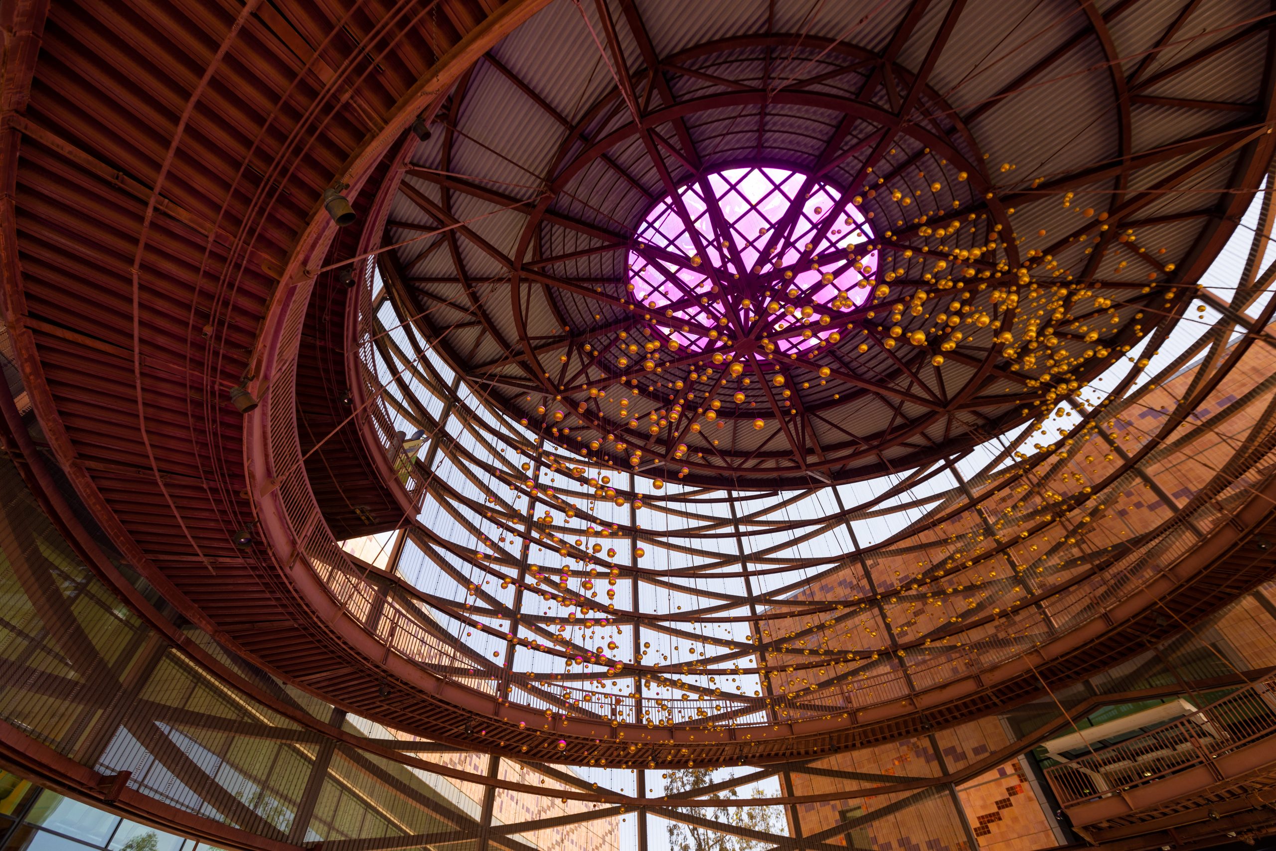 an abstract sculpture showing balls suspended in the air