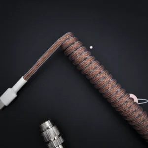 Brown coiled cable usb c top view Coiled brown paracord keyboard cable with USB-C connector, featuring a sleek finish and high-quality braiding. Suitable for custom setups.