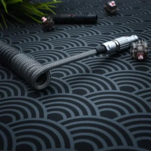 Dark gray coiled cable angled lemo pattern Coiled dark gray keyboard cable featuring a sleek braided design and detachable connectors. The metal housing adds durability, perfect for custom setups.