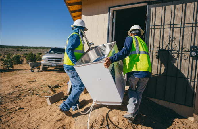 Men installing a new sink in a Navajo home Men installing a new sink in a Navajo home