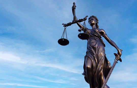 Lady Justice on a Blue Sky Background.