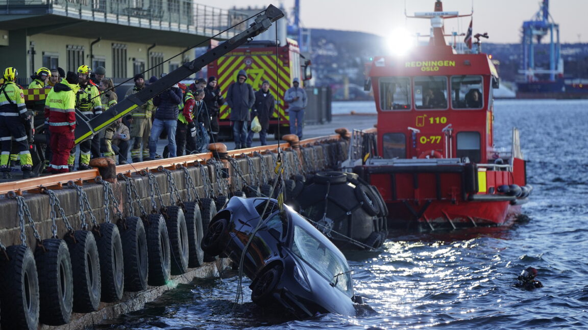 Rescue personnel retrieve a Tesla car from the water after driving out into the Oslofjord on February 1, 2024 in Oslo. Two occupants of a car that had plunged into the Oslo fjord were rescued on February 1, 2024 by a... floating sauna, the Norwegian police announced. According to an officer quoted by the media, the two occupants were unharmed.