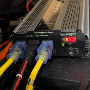 Three extension cords plugged into a windynation inverter, with "850" showing on a red LED display.