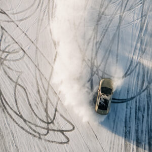 A top-down view of a gold Polestar EV drifting on the ice