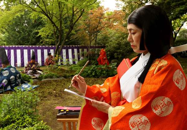 poem. A poet in a Heian period kimono writes Japanese poetry during the Kamo Kyokusui No En Ancient Festival at Jonan-gu shrine on April 29, 2013 in Kyoto, Japan. Festival of Kyokusui-no Utage orignated in 1,182, party Heian era (794-1192).