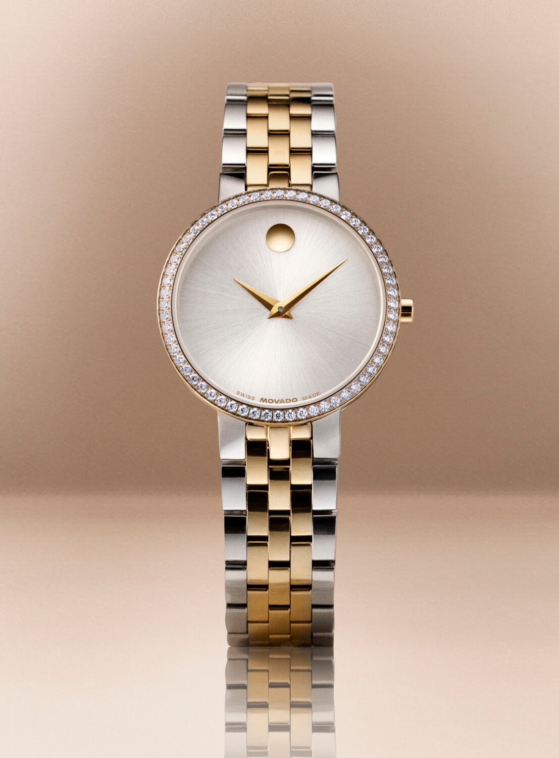 Two tone Museum Classic watch with lab grown diamond bezel in front of a tan background