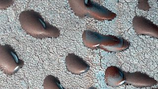 Frozen sand dunes sit locked in place in Mars' northern hemisphere, stuck until the spring thaw melts their icy shells