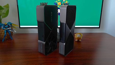 Nvidia GeForce RTX 5080 on right and RTX 4080 on left standing upright on woodgrain desk