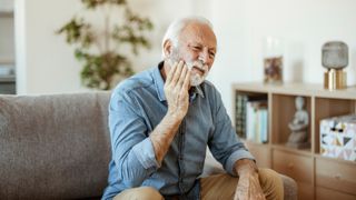 man suffering with tooth ache