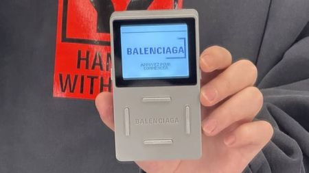 Hand holding Balenciaga handheld console