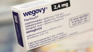 A close-up image of a box of the drug wegovy. The box is white with blue writing across it.