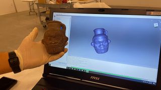 A picture of a 3-D replica of the Egyptian Bes mug