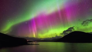 A photo of an aurora over a lake