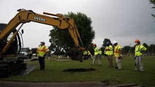 Archaeologists and observers watch during a test excavation of the 1921 Tulsa Race Massacre Graves at Oaklawn Cemetery in Tulsa, Oklahoma, on July 13, 2020.