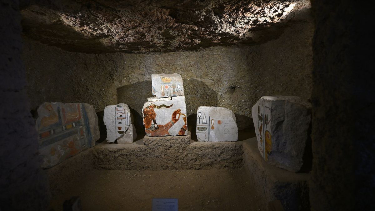 Colorful stone blocks with ancient Egyptian drawings in a rock-cut room