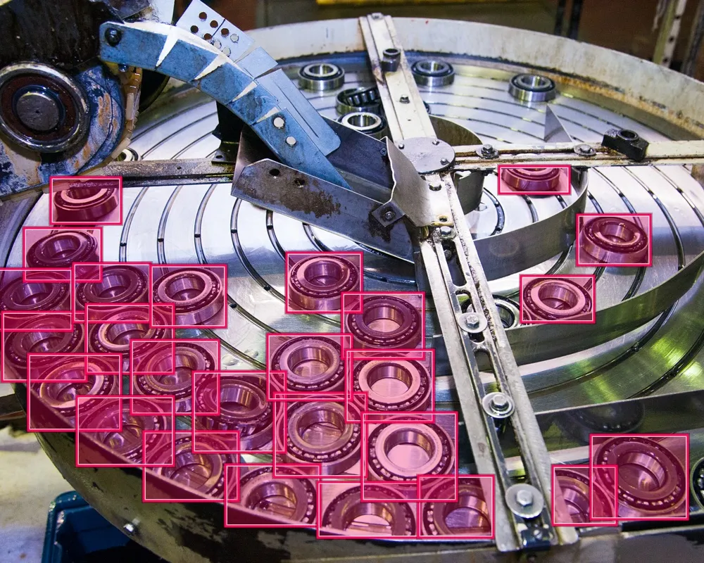 Ball bearings in production line, with bounding boxes around the ball bearings