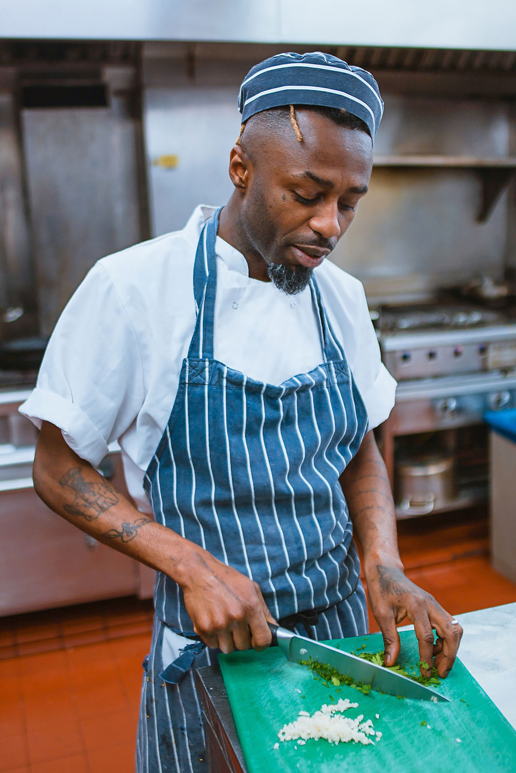 Masked chef's concentrating on preparing food.