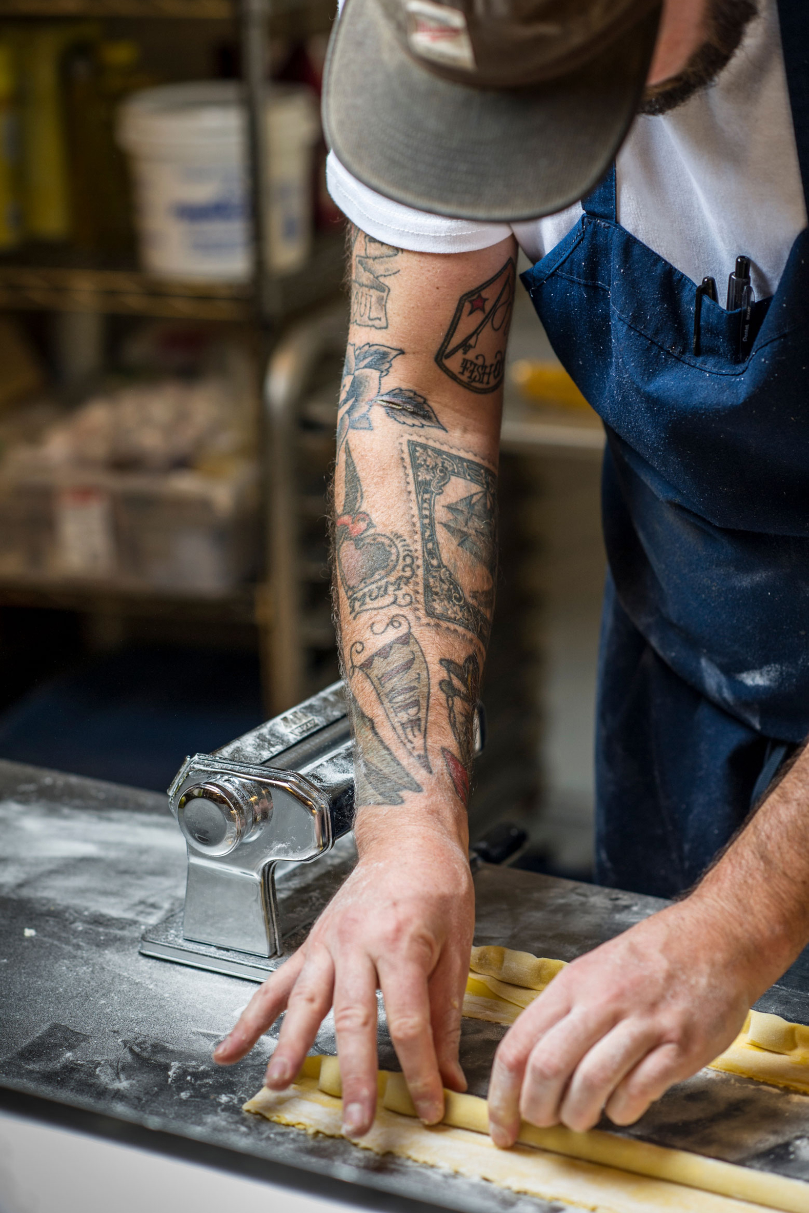 A chef carefully seasoning a bowl of ingredients