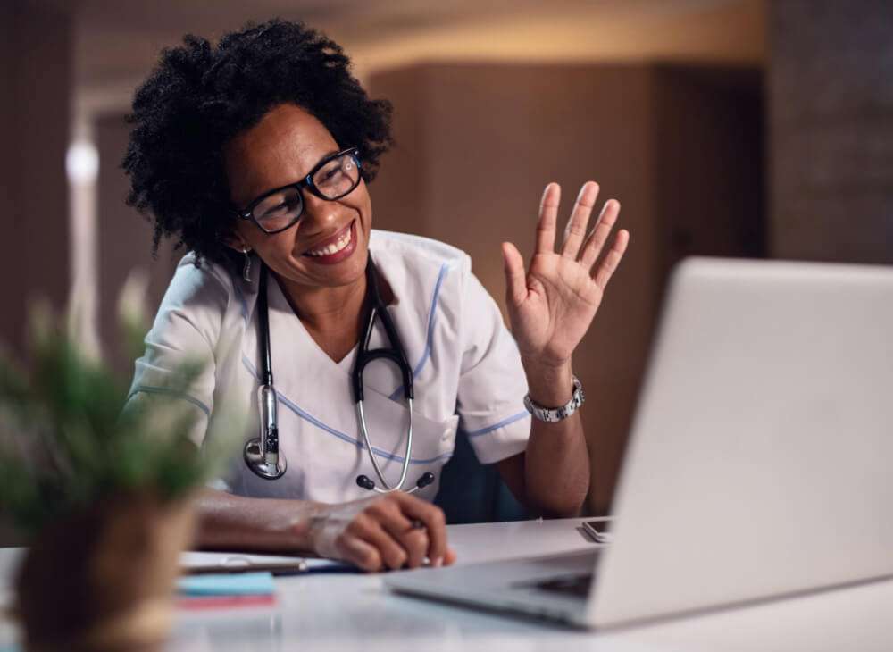 Woman waiving on video call