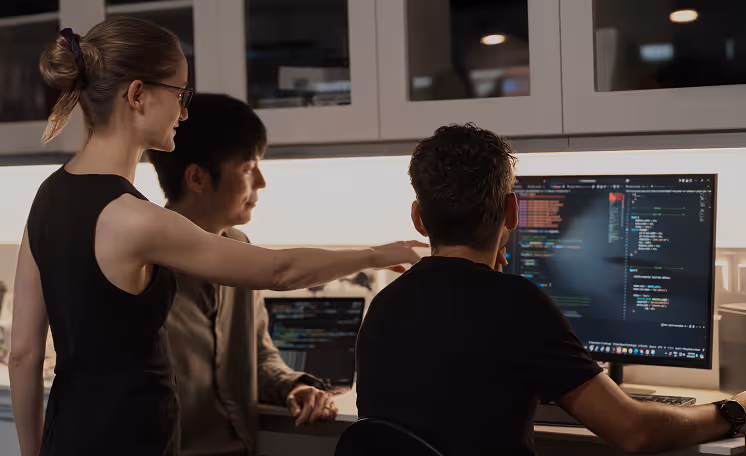 Q-CTRL team looking at a computer