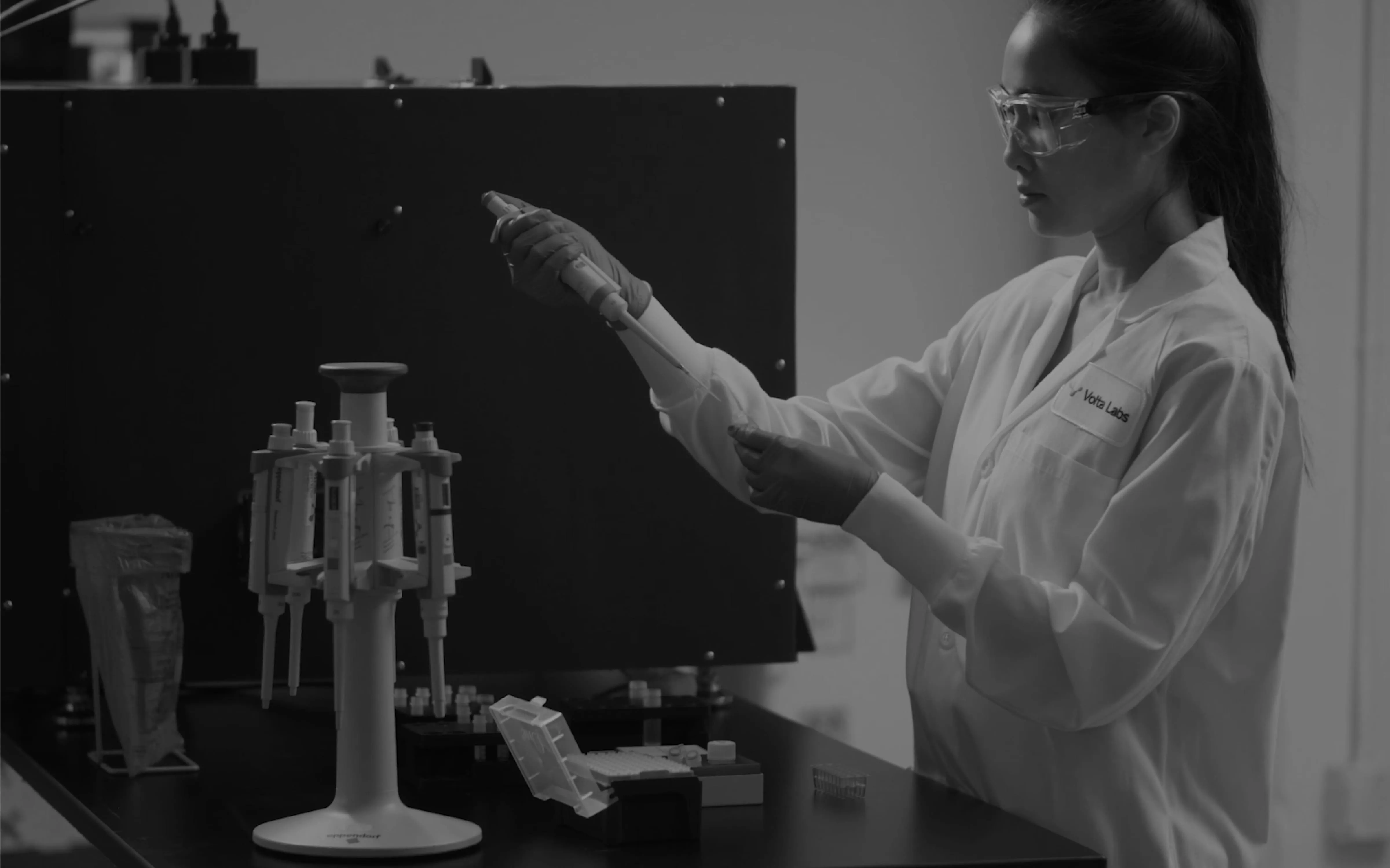 A female scientist handling materials in a laboratory.