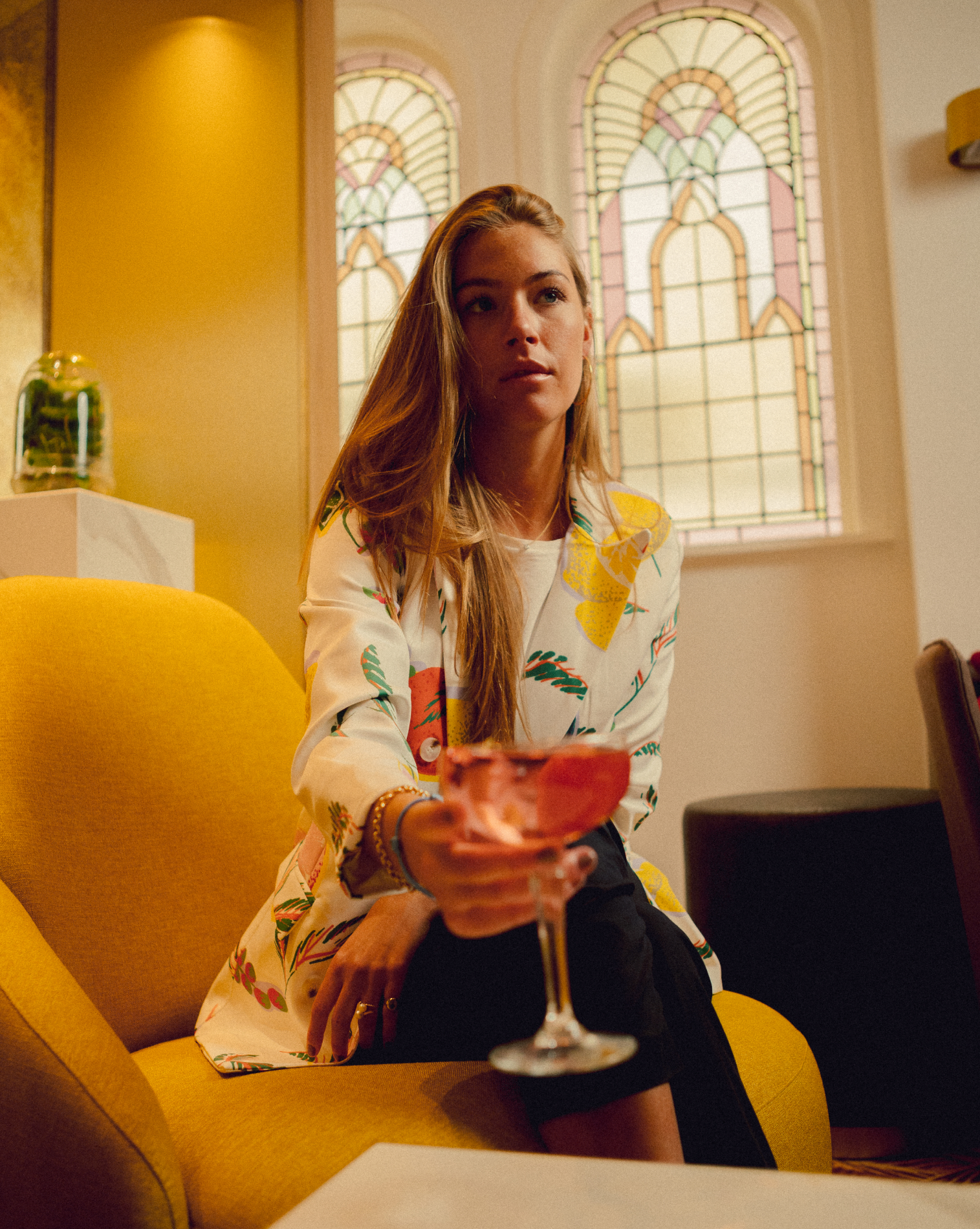 blond girl holding a paloma cocktail