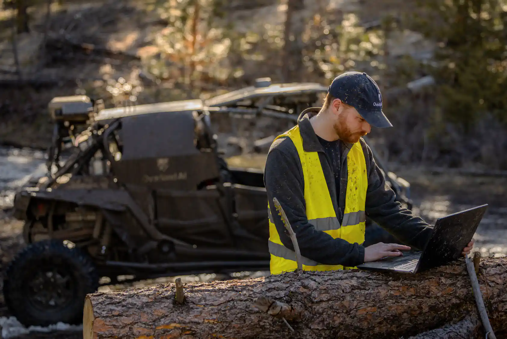 The Overland AI team working on a vehicle