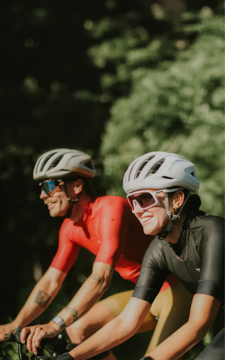 Two cyclists riding bicycles on a trail.