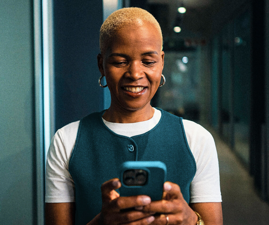 A woman holding a phone and watching it