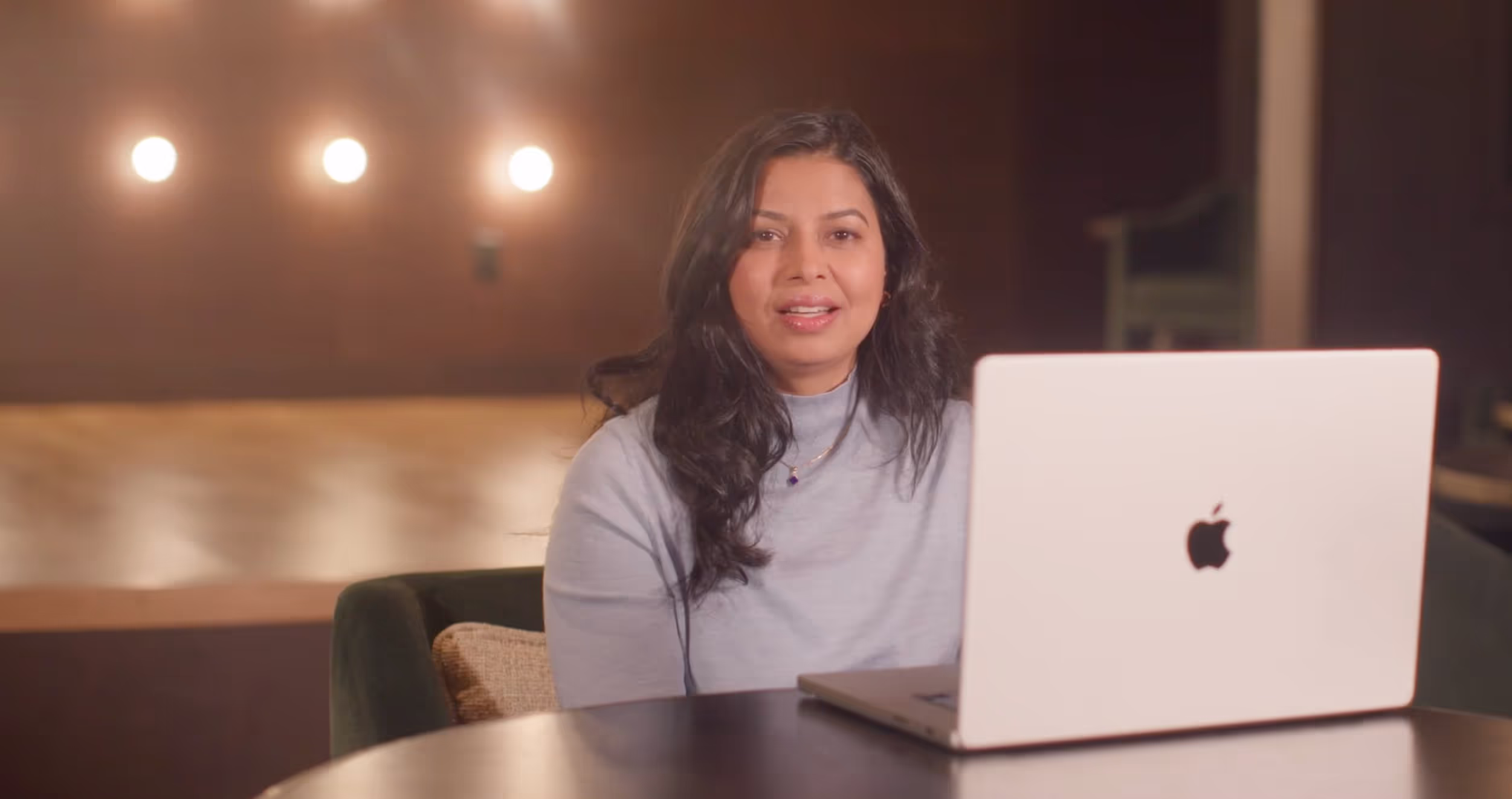 Woman sitting at a table with a laptop
