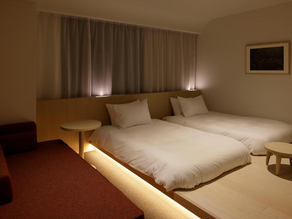 Tempat tidur dalam kamar di SOKI Kanazawa