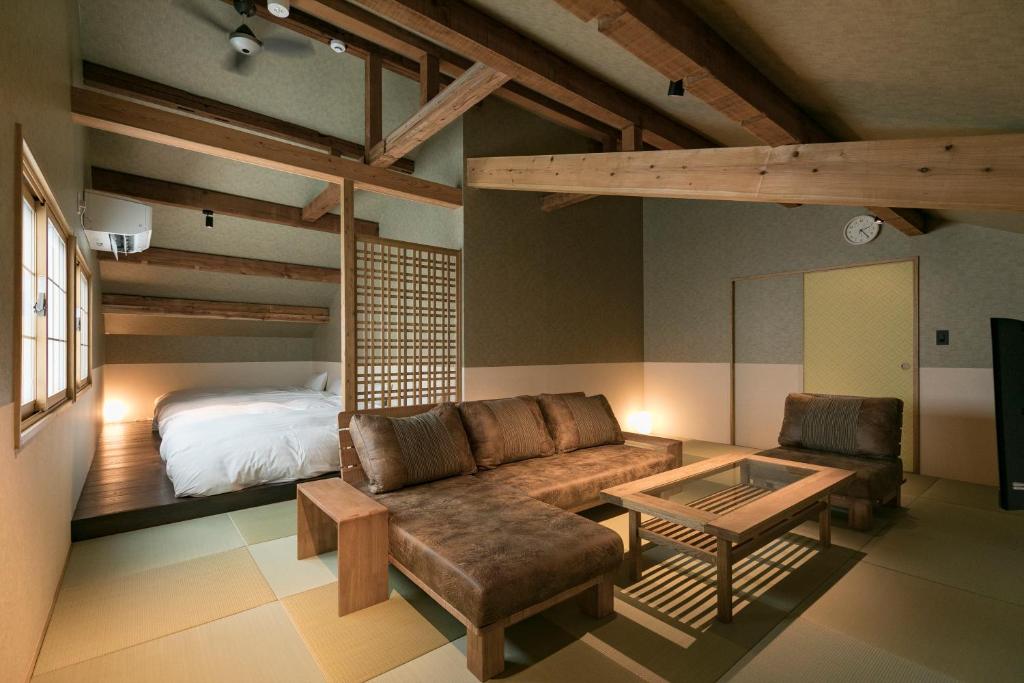 a living room with a couch and a bed at Asobe in Aso