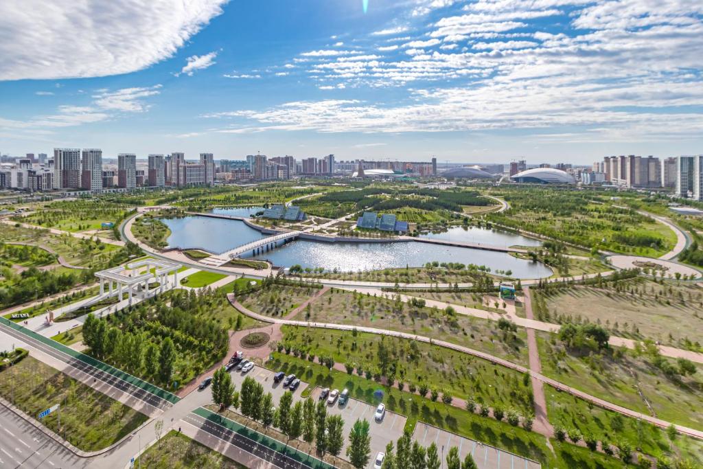 an aerial view of a park with a city in the background at Отель у Ботанического Сада, в самом центре in Astana