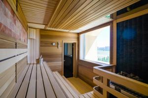 a sauna with a bench and a window at The ONE Hotel Astana in Astana