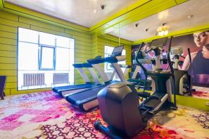 a gym with cardio equipment in a room at The ONE Hotel Astana in Astana