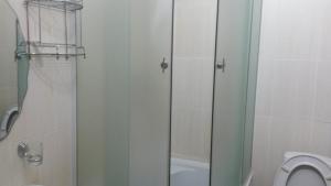 a bathroom with a shower and a toilet at Hotel Shagyn in Astana