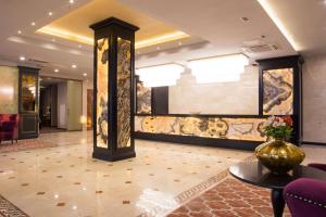 a lobby of a hotel with a vase on a table at Best Western Plus Astana Hotel in Astana