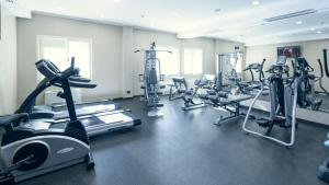 a gym with several treadmills and cardio machines at Comfort Hotel Astana in Astana