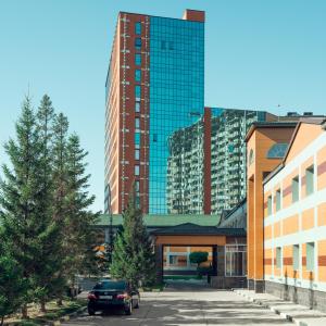 a parking lot in front of a tall building at Comfort Hotel Astana in Astana