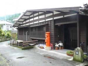 a building with an orange object in front of it at Ryokan Yamashiroya in Yufuin