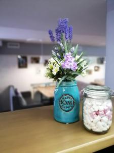 a blue jar with flowers in it on a table at Sultan Beibarys in Astana