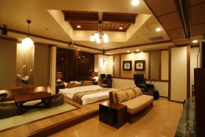 a bedroom with a bed and a living room at Hotel & Spa Lotus (Adult Only) in Kyoto