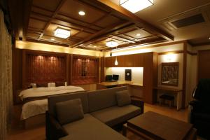 a hotel room with a bed and a couch at Hotel & Spa Lotus (Adult Only) in Kyoto