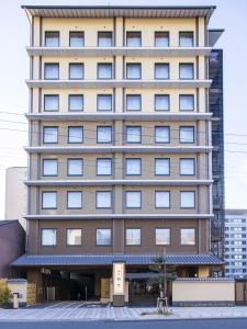 a tall building with a lot of windows at Onyado Nono Kyoto Shichijo Natural Hot Spring in Kyoto