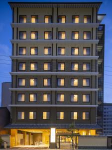 a tall building with many windows at night at Onyado Nono Kyoto Shichijo Natural Hot Spring in Kyoto