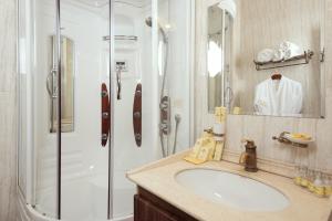 a bathroom with a sink and a shower at Boutique Hotel Traditional in Astana