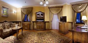 a living room with a couch and a tv at Boutique Hotel Traditional in Astana