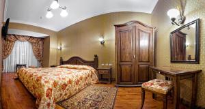 a bedroom with a bed and a table and a desk at Boutique Hotel Traditional in Astana