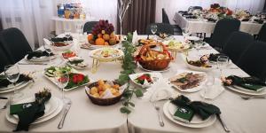 a long table with plates of food on it at MirOtel Hotel in Astana