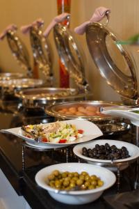 a bunch of plates of food on a buffet at Comfort Hotel Astana in Astana